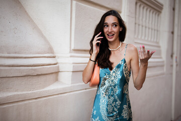 Beautiful young elegance woman using the phone. Beautiful fashion woman talking to the phone