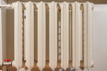 Old cast iron heating radiator connected to central system