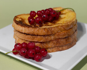 Traditional French toast with figs and red currants. Fried bread soaked in a mixture of milk, eggs and sugar.