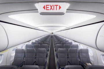 Interior of passenger airplane with exit sign