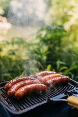 Close up of sausages on a grill in nature.