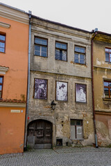shabby old buildings in the historic city center of lublin with old photographs from the city's history
