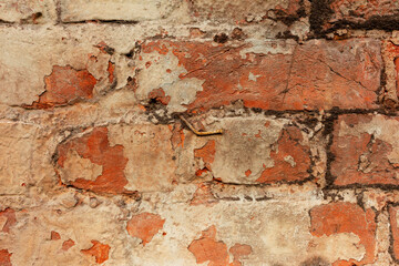 brick wall with rusty nail