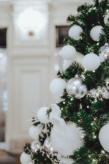 Festive Christmas tree decorated with Christmas toy silver ball. Winter holiday celebration. New Year concept. Christmas vertical postcard