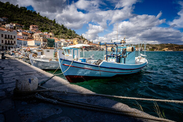 Naklejka na ściany i meble Small traditional fishing boat in a greek harbour