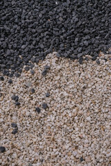 Decorative stones. Black, and white. Natural small stones for design. Vertical image. 