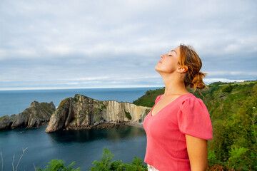 Woman breathing fresh air in a beautiful coast