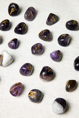 Viking ancient rune stones carved on gemstones.
Rune stone on a wooden table.