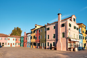 Fototapeta na wymiar Colorful houses in Burano island, Italy. Historic italian architecture in historic village not far from Venice.