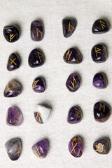 Viking ancient rune stones carved on gemstones.
Rune stone on a wooden table.
