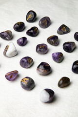 Viking ancient rune stones carved on gemstones.
Rune stone on a wooden table.
