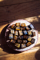Viking ancient rune stones carved on gemstones.
Rune stone on a wooden table.