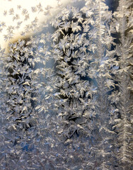 The texture of the glass is covered with frost in winter in cold weather. Abstract natural background. Macro.