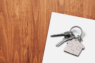 Keys and keychain on real estate document, contract agreement to buy or construction