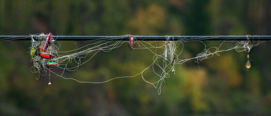 Tangle of fishing line and fishing lures on hydro line