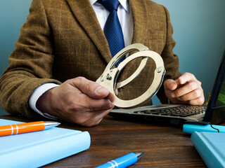 Financial crime concept. A man in a suit gives handcuffs.