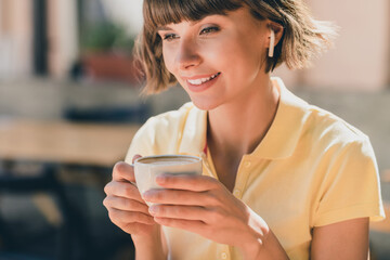 Cropped view portrait of attractive cheerful girl drinking latte talking on phone on fresh air...
