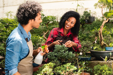 happy botanist talking to colleague at plant nursery