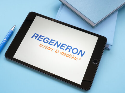 KYIV, UKRAINE - October 21, 2021. Regeneron Pharmaceuticals logo on the blue desk.
