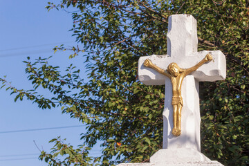 The crucifixion of Jesus Christ on a white stone cross