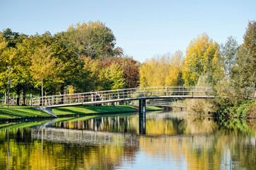Rotterdam, The Netherlands, October 24, 2021: two pedestrian bridges across a pond in Zuiderpark on a sunny day in autumn