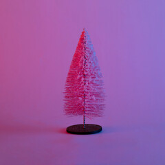 christmas tree with neon pink and blue lights. modern futurism 2022 year background. minimalism. surrealism. creative decoration idea