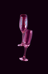 two glasses of champagne with neon pink lights. modern futurism 2022 year background. minimalism. surrealism. creative decoration idea