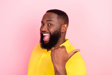 Photo of afro american cheerful positive young man point finger empty space sale news isolated on...