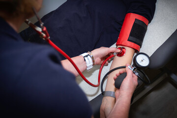 Nurse cheking blood pressure on patient