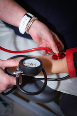 Nurse cheking blood pressure on patient