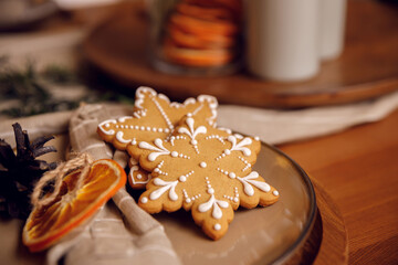 gingerbread cookie on a plate on a wooden table. For recipes. Festive table setting. Home comfort and warm atmosphere. New Year and Christmas. Baking for dessert.
