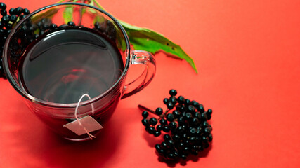 Top view of a mug of red tea. Natural herbal tea, medicinal from black elderberry berries....