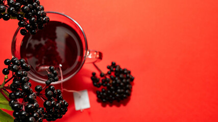 Top view of a mug of red tea. Natural herbal tea, medicinal from black elderberry berries....