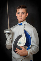 A young swordsman in ammunition and with a sword in his hand