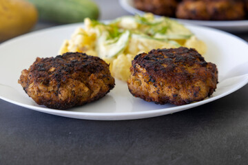 German meatballs called Frikadellen served with cucumber potato salad