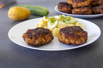 German meatballs called Frikadellen served with cucumber potato salad