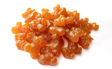 Close-up texture of orange and yellow multivitamin gummies in the form of bears on white...