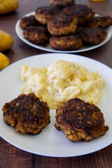 German meatballs called Frikadellen served with potato salad