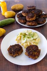 German meatballs called Frikadellen served with cucumber potato salad