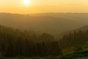 mountains in fog at sunset