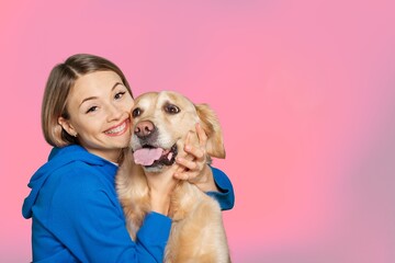 Woman embracing cute puppy pet