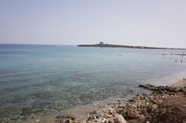 Portopalo di Capopassero , Italy - September 18, 2021 : View of Capopassero island from Scalo Mandrie beach