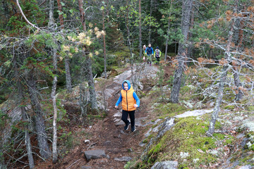 Child climbing Mount Hiidenvuori in summer