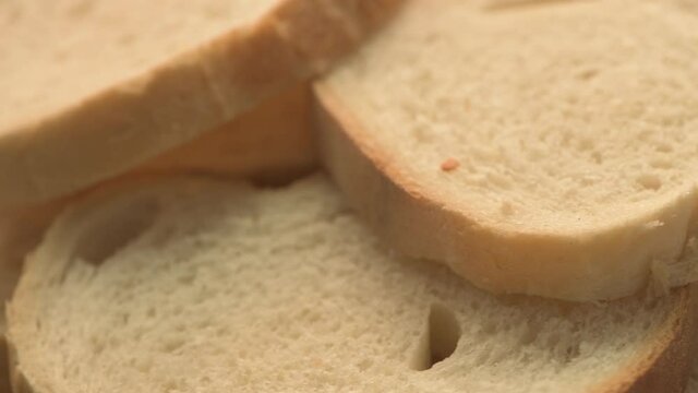 Slices of white bread on turning plate, close up
