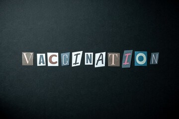 Vaccination words. Caption, heading made of letters with different fonts on a dark background.
