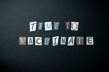Time to vaccinate words. Caption, heading made of letters with different fonts on a dark background.