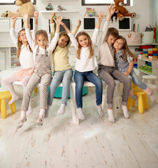 Group of kindergarten kid friends sitting and having fun
