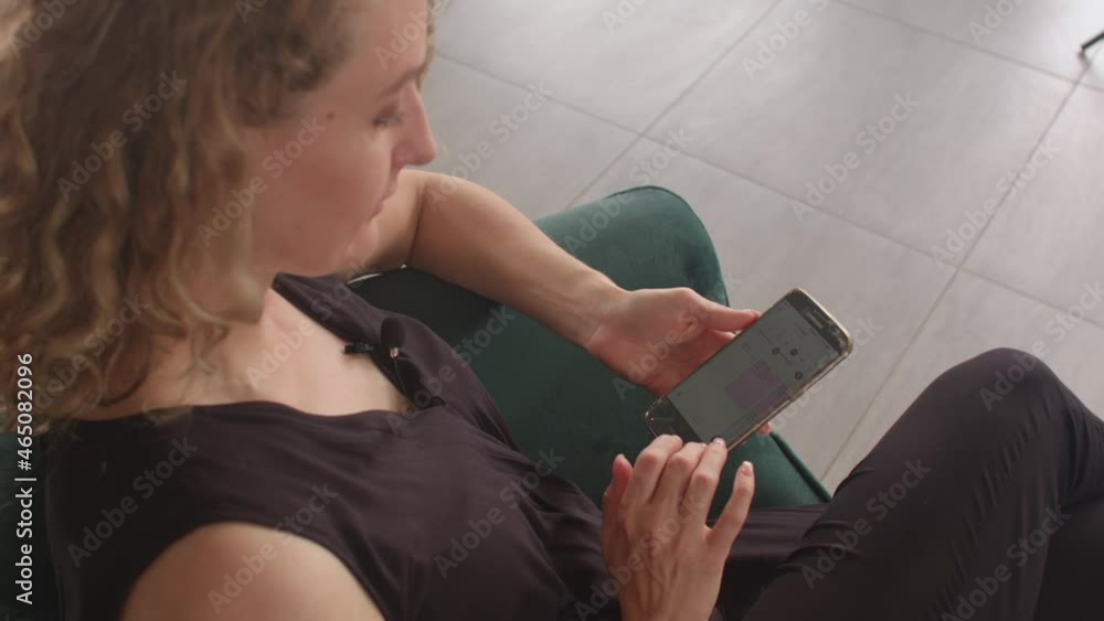 Poster using a mobile application in a smartphone. pressing the screen of the device. free time with the em
