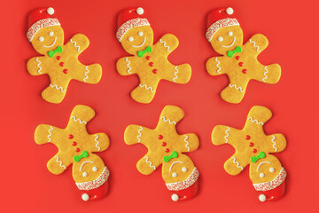 Traditional gingerbread man with icing Christmas new year cookies, flat lay pattern on red background