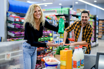 Beautiful couple buying groceries at the supermarket